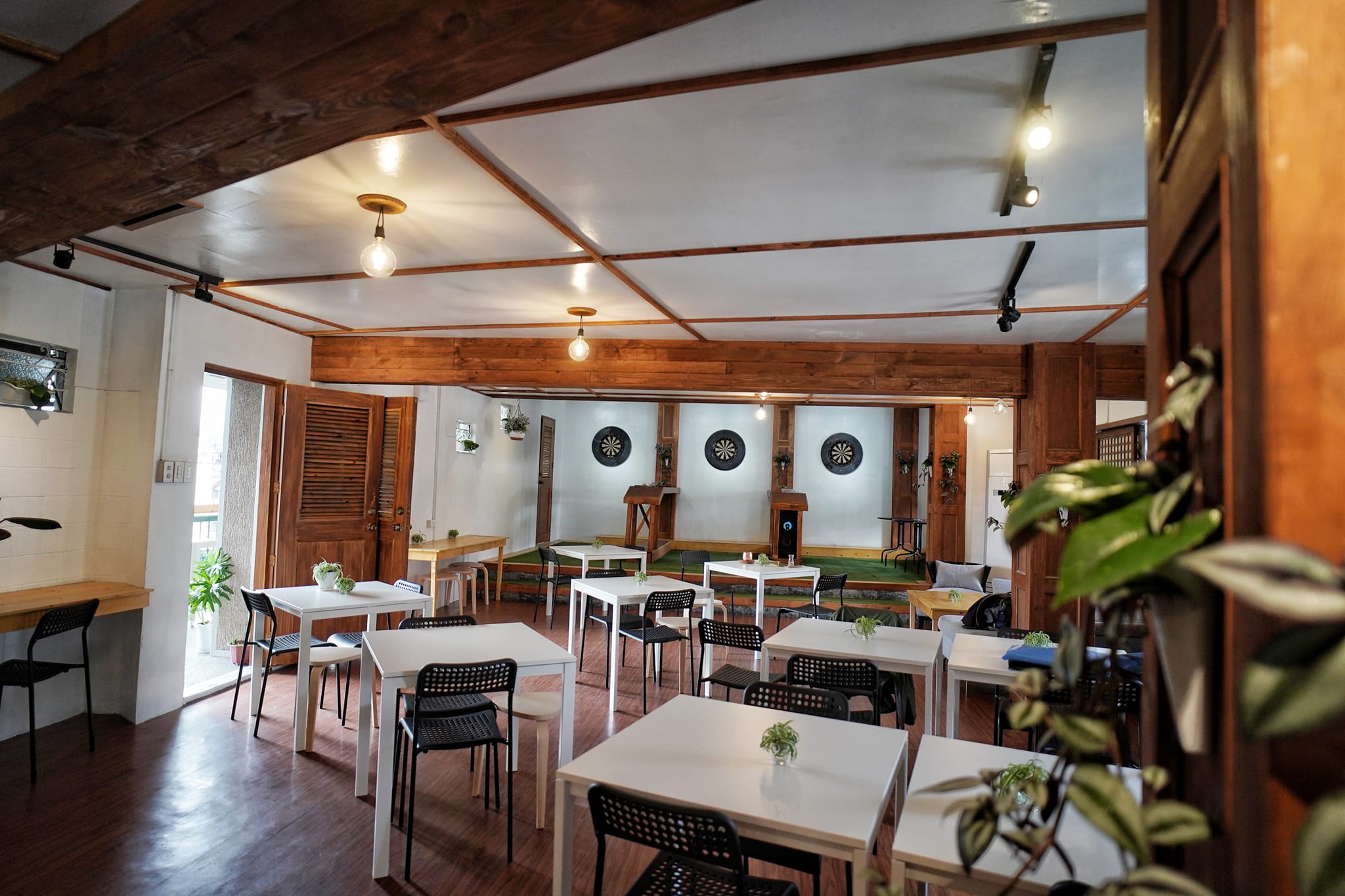 The dart room at 2nd Home Coffee Shop — tables and dart boards
